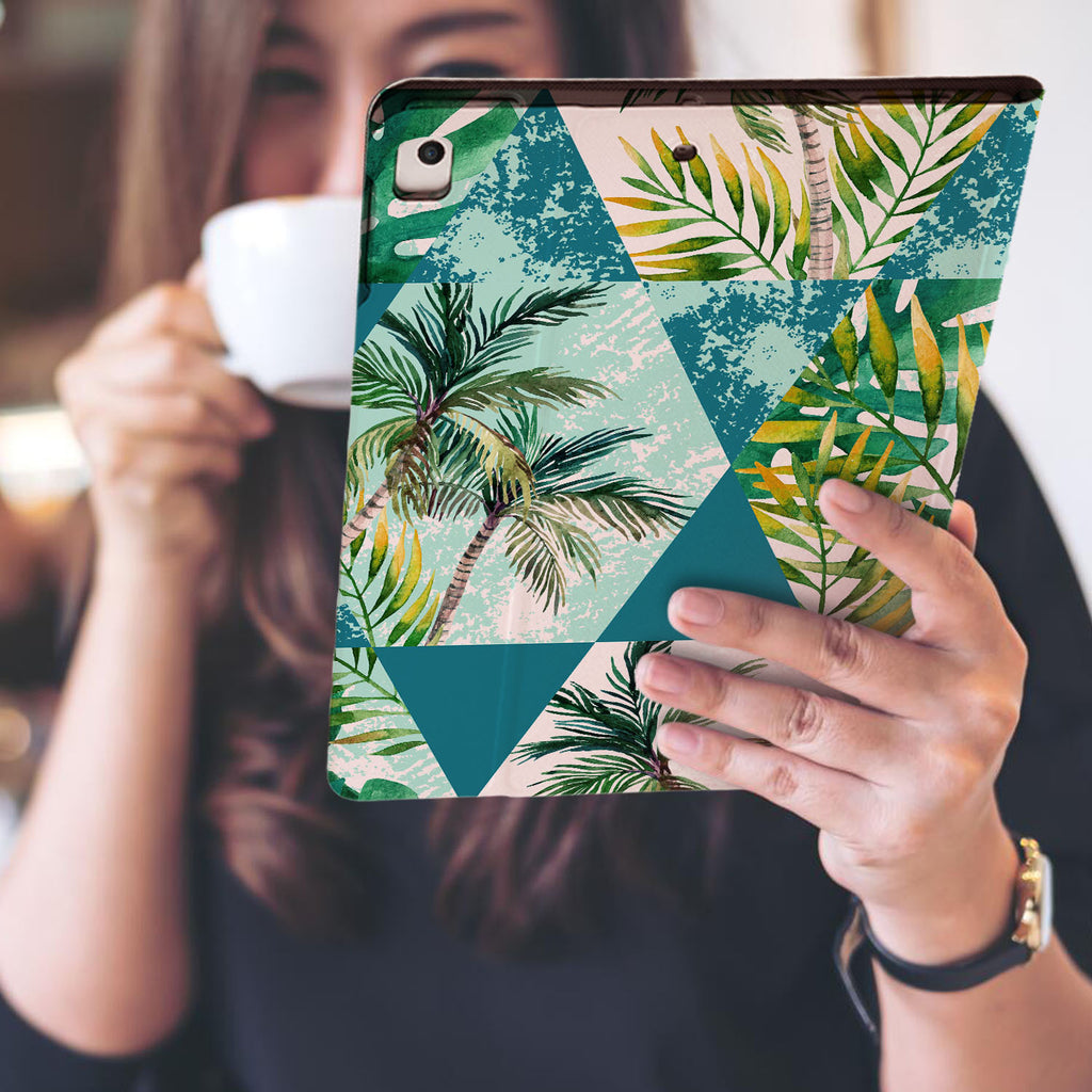 a girl is holding and viewing personalized iPad folio case with Tropical Leaves design